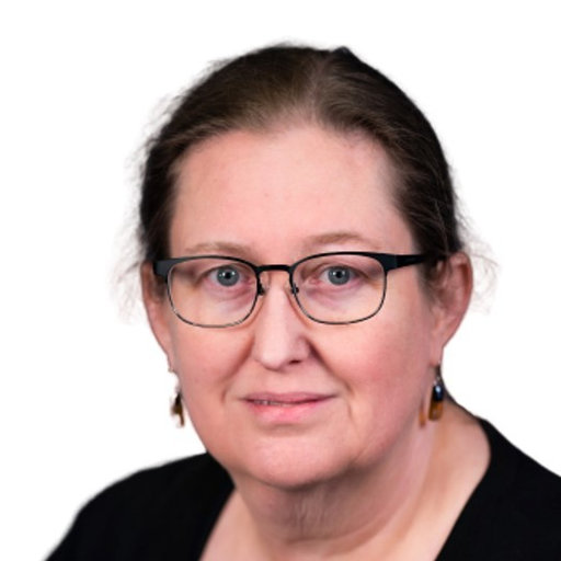 Headshot of Margaret Nygren. Margaret wears glasses and a black shirt.