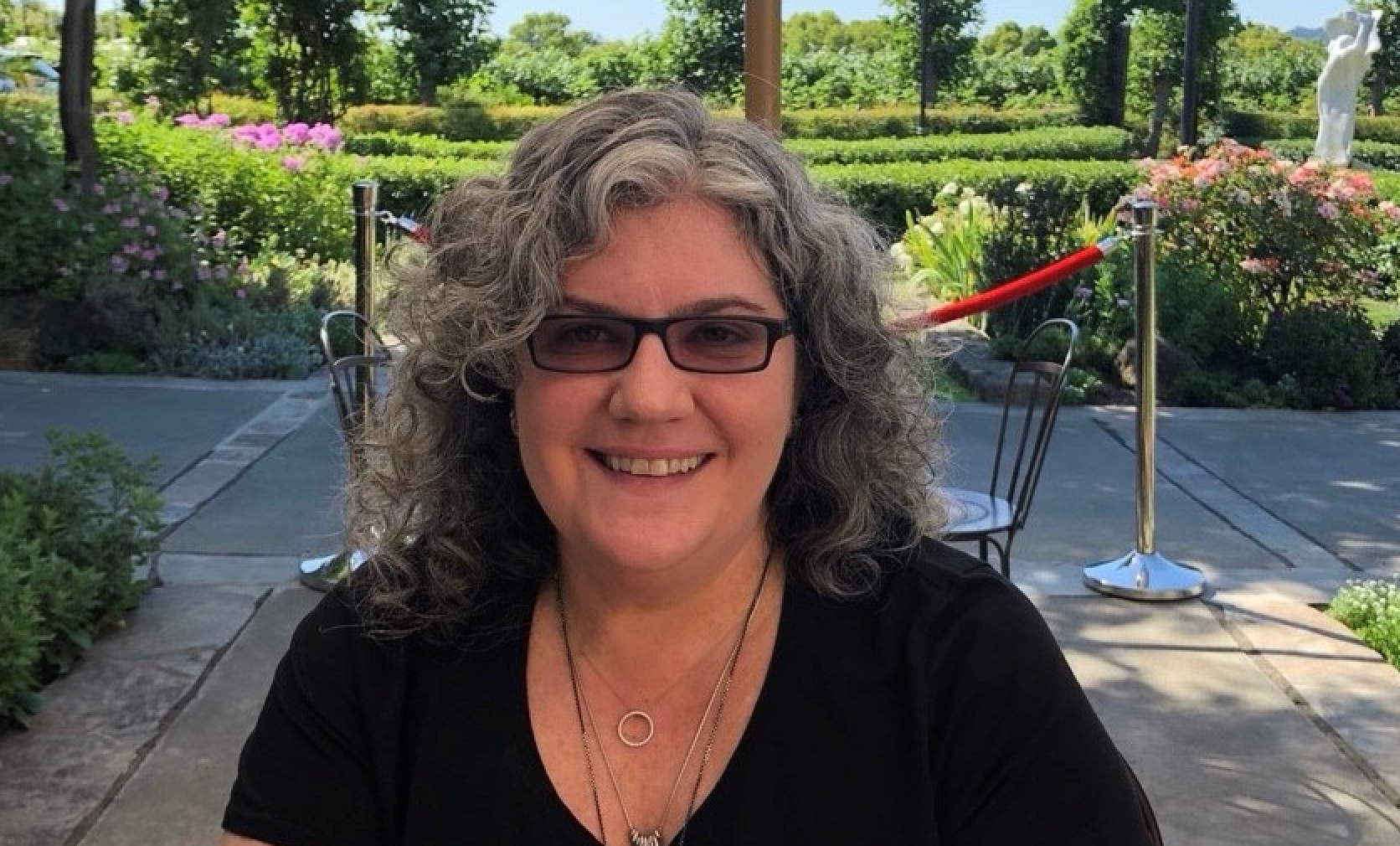 Headshot of Merrill Friedman. Merrill wears glasses and a black shirt.